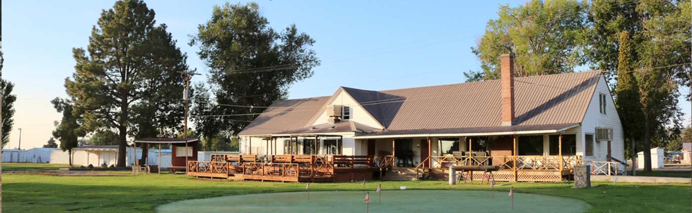putting green in front of a golf clubhouse