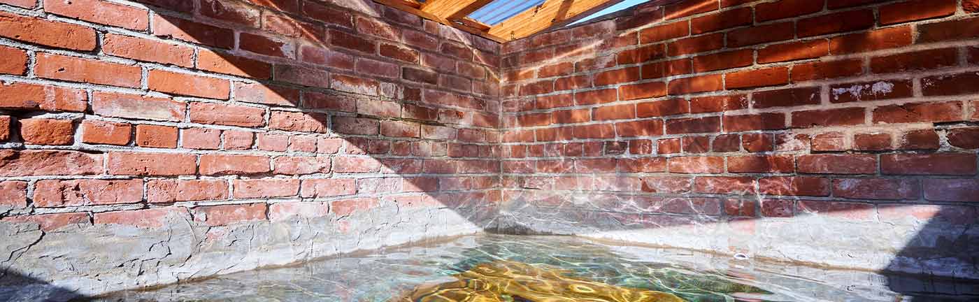 hot spring enclosed by a brick wall